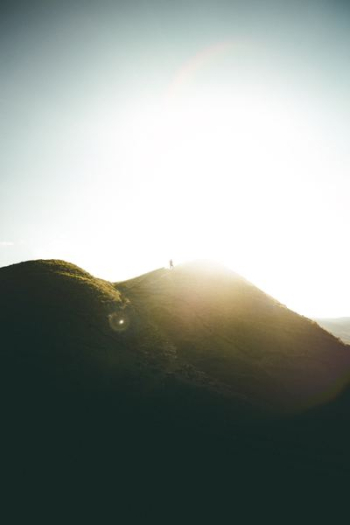 man standing on top of moutain man standing on top of moutain