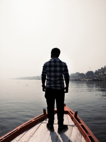 Man Standing On Wooden Boat Man Standing On Wooden Boat