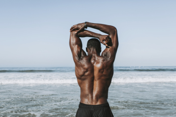 Man Stretching Arms in Front of Ocean Man Stretching Arms in Front of Ocean
