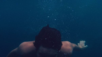 man submerged on body of water man submerged on body of water