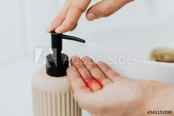 Man using a soap dispenser Man using a soap dispenser