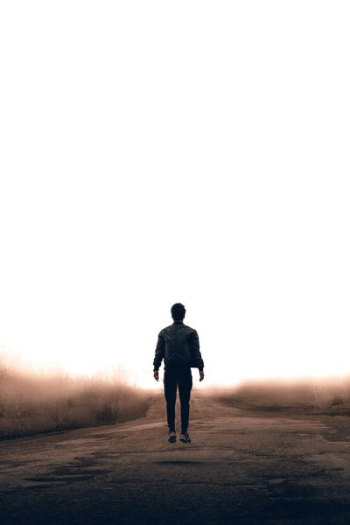 man walking along road man walking along road