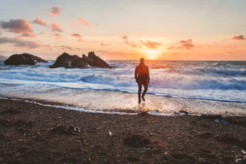 man walking in beach during golden hour man walking in beach during golden hour