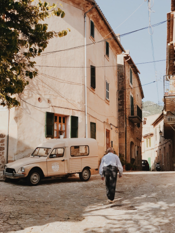 Man Walking Near Beige Truck