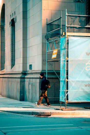 Man Walking Near Scaffolding Man Walking Near Scaffolding