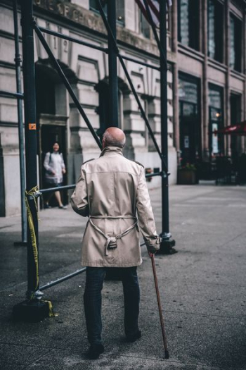 man walking near scaffolding during daytime man walking near scaffolding during daytime