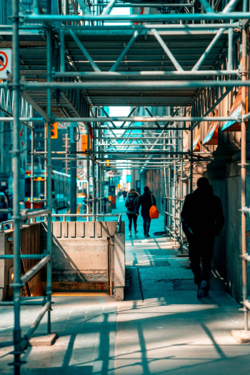 Man Walking Under Scaffolding Man Walking Under Scaffolding