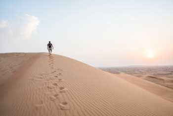 Man Walking Up Sand Dunes Man Walking Up Sand Dunes