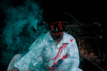 Man Wearing A Black Mask And Bloody Shirt Man Wearing A Black Mask And Bloody Shirt