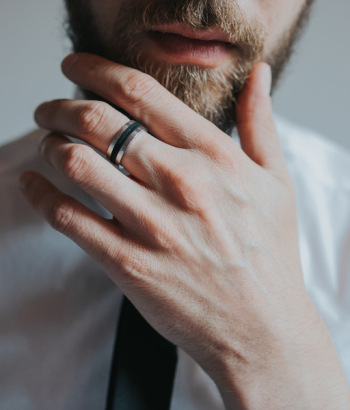 Man Wearing Band Ring Touching Beard