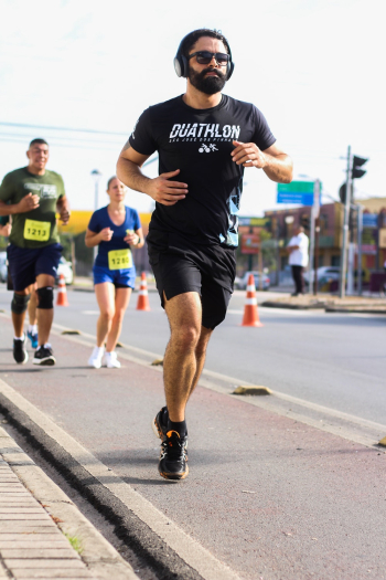Man Wearing Black Crew-neck T-shirt and Black Short Running Marathon on Sidewalk