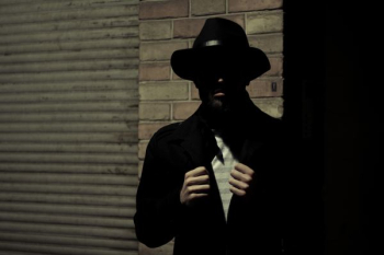man wearing black fedora hat and black suit jacket man wearing black fedora hat and black suit jacket