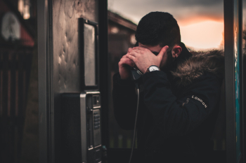 Man Wearing Black Parka Jacket Holding Telephone Man Wearing Black Parka Jacket Holding Telephone