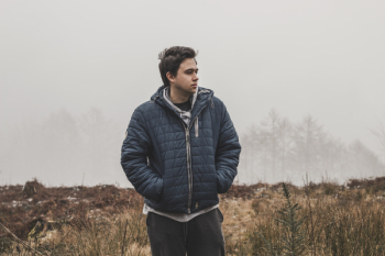 Man Wearing Black Zip-up Hooded Jacket Standing Man Wearing Black Zip-up Hooded Jacket Standing