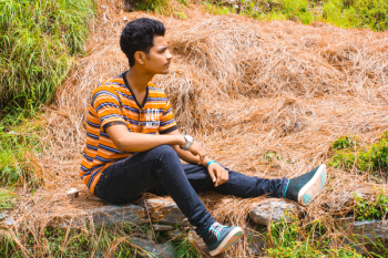 Man Wearing Blue Jeans Sitting on Brown Hay Man Wearing Blue Jeans Sitting on Brown Hay