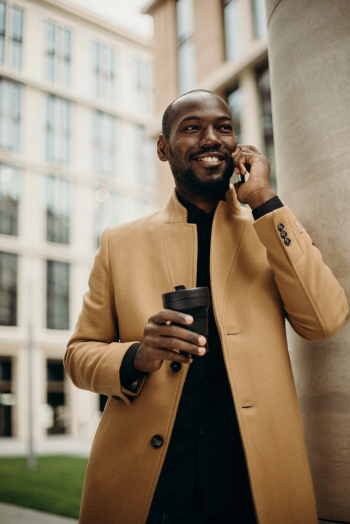 Man Wearing Brown Jacket Using Smartphone While Using Smartphone Man Wearing Brown Jacket Using Smartphone While Using Smartphone