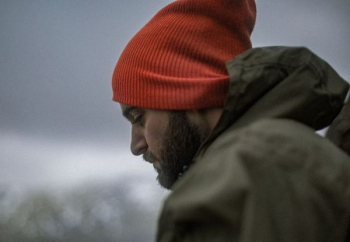 man wearing gray hoodie and orange knit cap man wearing gray hoodie and orange knit cap