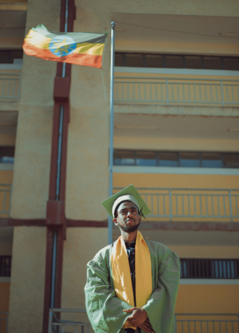 Man Wearing Green and Yellow Graduation Gown Man Wearing Green and Yellow Graduation Gown