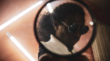 Man Wearing Hippie Sunglasses Seen Through Mirror Man Wearing Hippie Sunglasses Seen Through Mirror