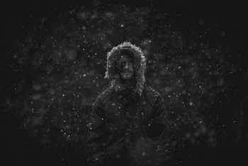 man wearing parka jacket in snow man wearing parka jacket in snow