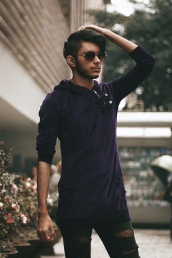 Man Wearing Purple Hoodie Holding Head Man Wearing Purple Hoodie Holding Head