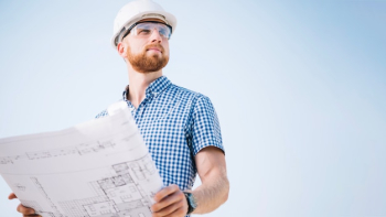 Man with blueprint looking away Man with blueprint looking away