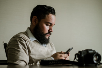 Man With Facial Hair Holds Smartphone Man With Facial Hair Holds Smartphone