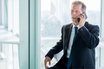 Mature businessman talking on smartphone Mature businessman talking on smartphone