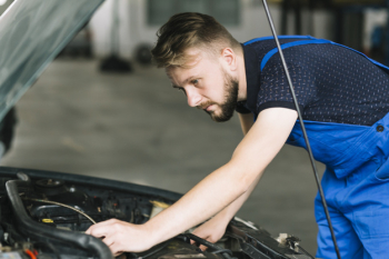 Mechanic repairing car motor Mechanic repairing car motor