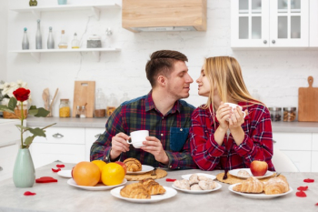 Medium shot happy couple having breakfast Free Photo Medium shot happy couple having breakfast Free Photo