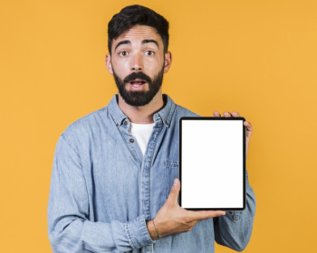 Medium shot surprised guy holding a tablet Free Photo Medium shot surprised guy holding a tablet Free Photo