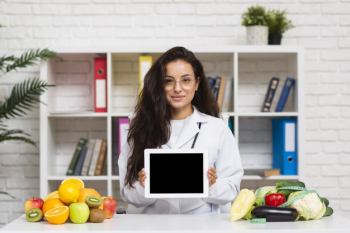 Medium shot young doctor with tablet mock-up Free Photo