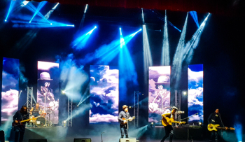 Men Playing Musical Instruments On Stage Men Playing Musical Instruments On Stage