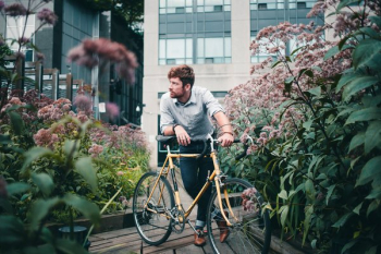 Men's Fashion Man With Bicycle Surrounded By Flowers