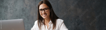 Mid aged brunette businesswoman in shirt sitting