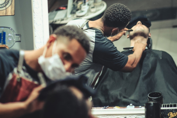 Mirror Reflection of Man Shaving Man&#39;s Beard