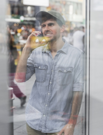 Mirroring image man talking at phone Free Photo