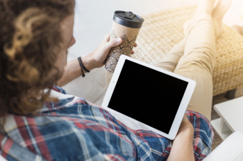 Modern man with table on couch Modern man with table on couch