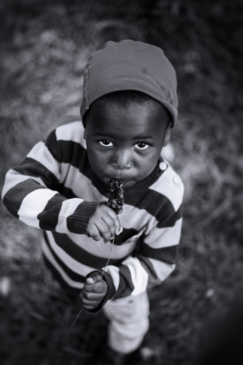 Monochrome Photo of Kid Eating
