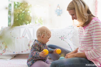Mother and baby daughter playing with balls Mother and baby daughter playing with balls