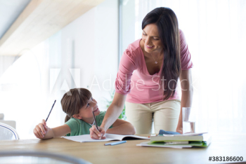 Mother and daughter coloring at dining table Mother and daughter coloring at dining table