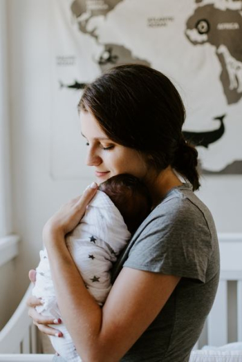 mother carrying baby mother carrying baby
