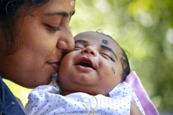Mother Kissing Child On Cheek Mother Kissing Child On Cheek