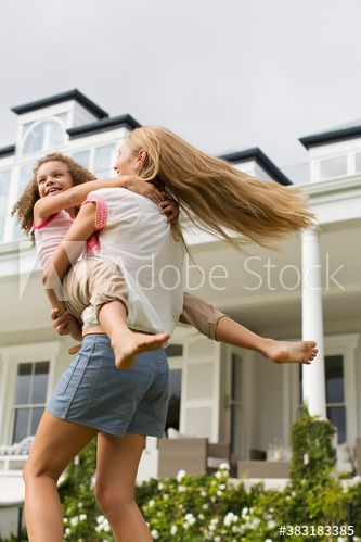 Mother spinning daughter in backyard Mother spinning daughter in backyard