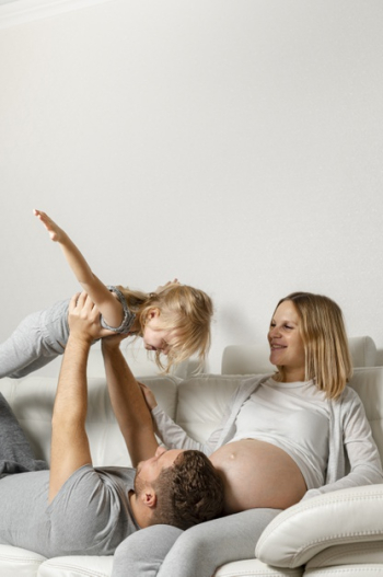 Mother watching father playing with little girl Free Photo