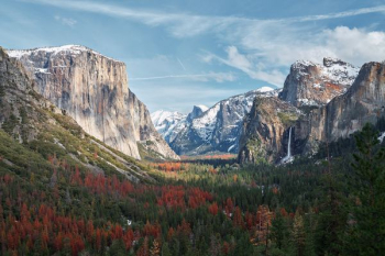 mountain surrounded by trees under cloudy sky mountain surrounded by trees under cloudy sky