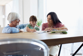 Multi-generation family coloring at dining table Multi-generation family coloring at dining table
