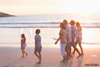 Multi-generation family, walking on beach at sunset Multi-generation family, walking on beach at sunset