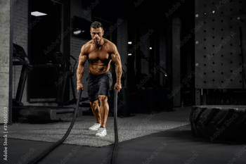 Muscular caucasian man training with ropes. Muscular caucasian man training with ropes.