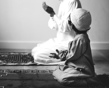 Muslim boy learning how to make Dua to Allah Muslim boy learning how to make Dua to Allah